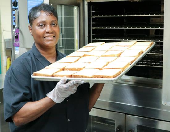 Marie Beard holds up a tray of grill cheese. 