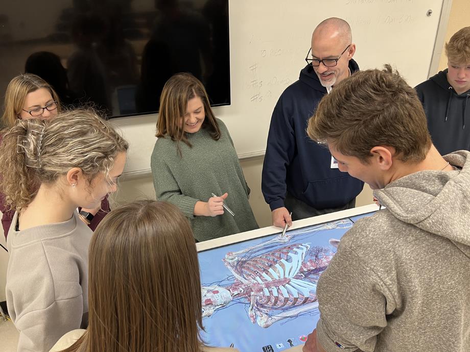 Teacher Nikki Akins reviews a lesson with students on the Anatomage Table.